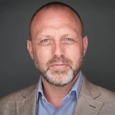 Headshot of Mark Pridmore, Head of Strategy and Business Development on a dark grey background