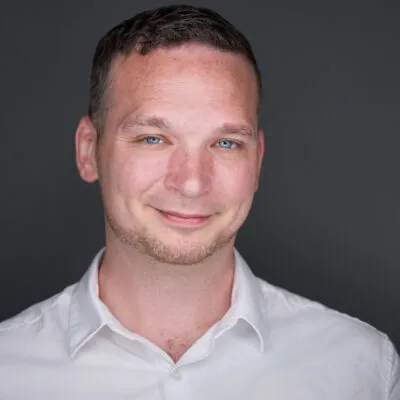 Headshot of Martin Dean, Head of Technology for Athera Healthcare against dark grey background